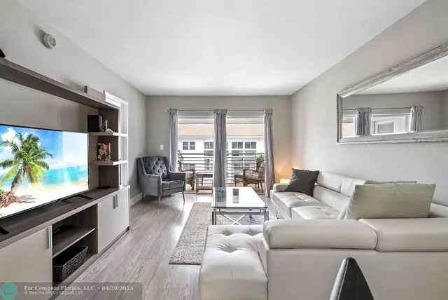 a view of a livingroom with furniture window and wooden floor