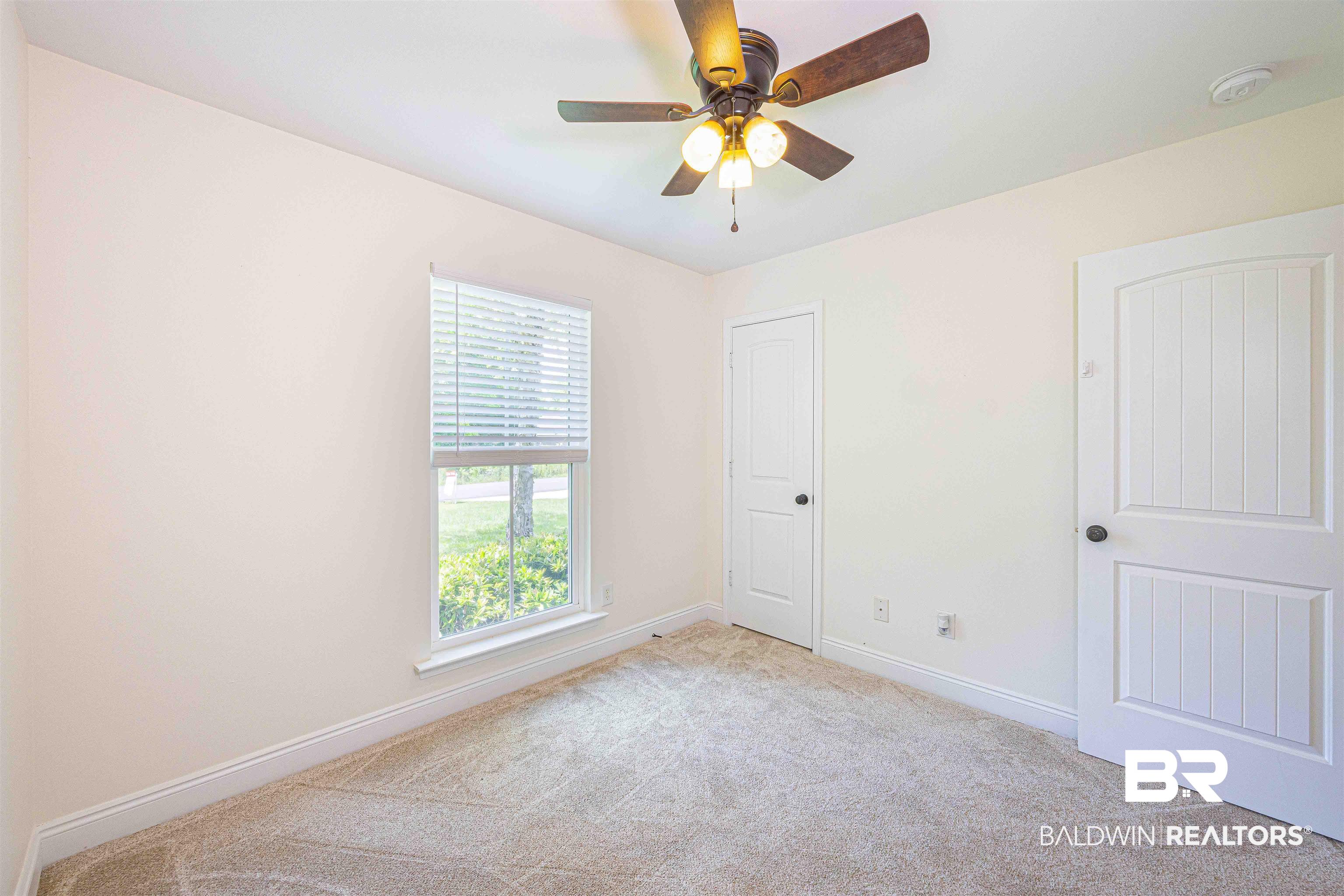 18675 Explorer Drive Loxley, AL 36551 - Photo 31 of 42 Unfurnished room with light colored carpet, baseboards, a smoke detector, and a ceiling fan