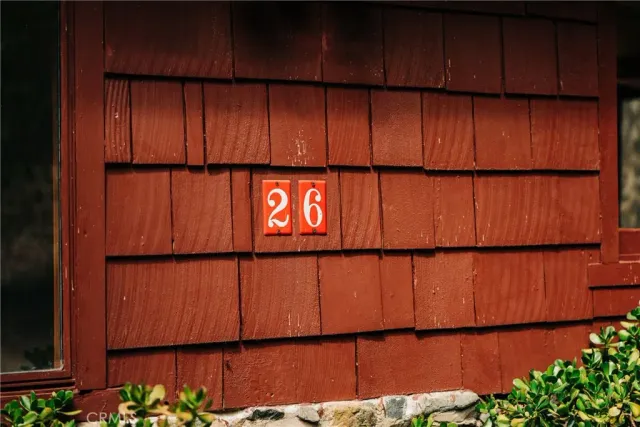 a view of a bathtub in a hall with wooden floor and a window