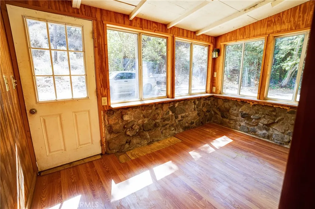 0 Hot Springs Canyon Road, Unit 26 San Juan Capistrano, CA 92675 - Photo 38 of 59 a view of an empty room with wooden floor and a window