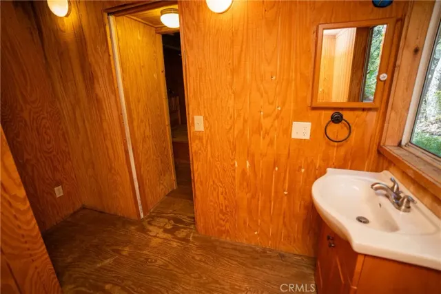 a view of an empty room with furniture wooden floor and windows