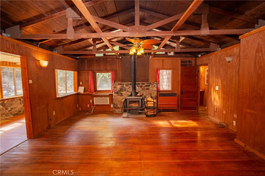 0 Hot Springs Canyon Road, Unit 26 San Juan Capistrano, CA 92675 - Photo 57 of 59 a view of a room with wooden furniture and chandelier