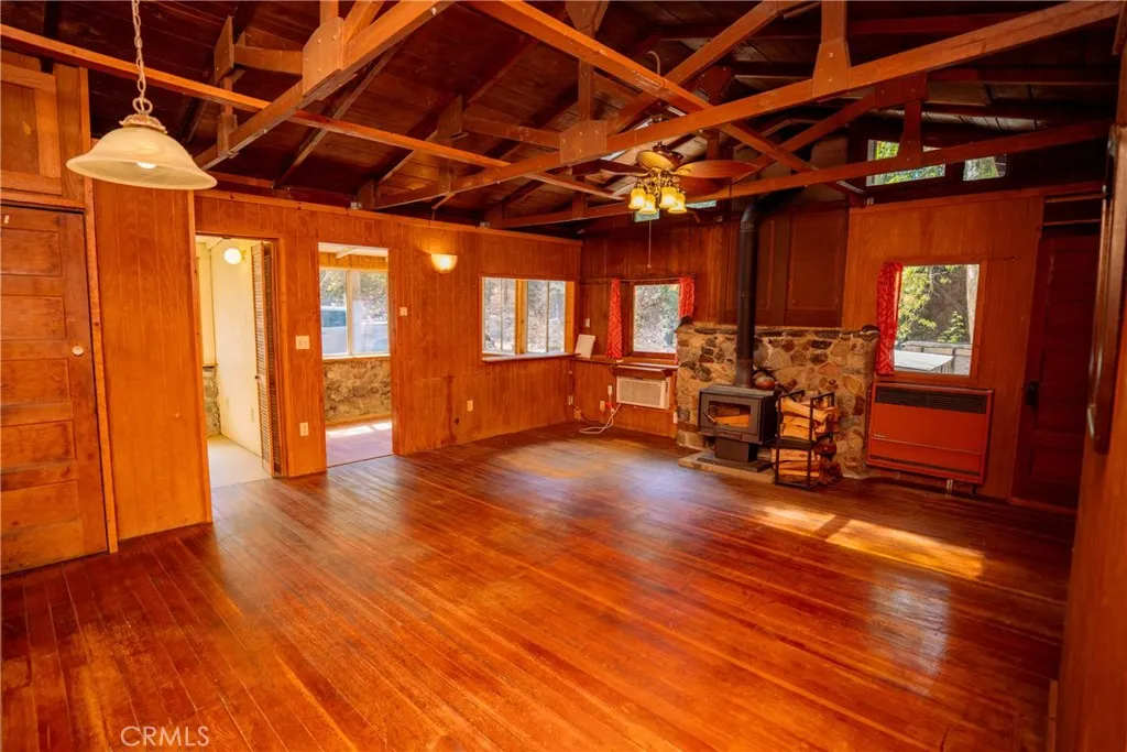 0 Hot Springs Canyon Road, Unit 26 San Juan Capistrano, CA 92675 - Photo 58 of 59 a view of an empty room with furniture wooden floor and windows