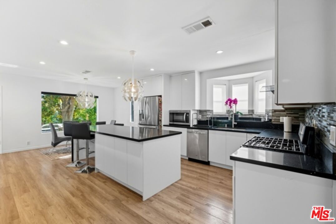 10915 Ayres Avenue Los Angeles, CA 90064 - Photo 12 of 51 a kitchen with counter top space a sink appliances and cabinets