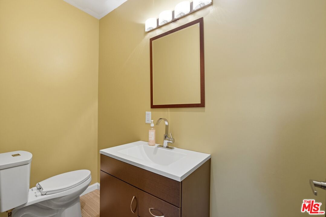 10915 Ayres Avenue Los Angeles, CA 90064 - Photo 16 of 51 a bathroom with a sink a toilet and mirror