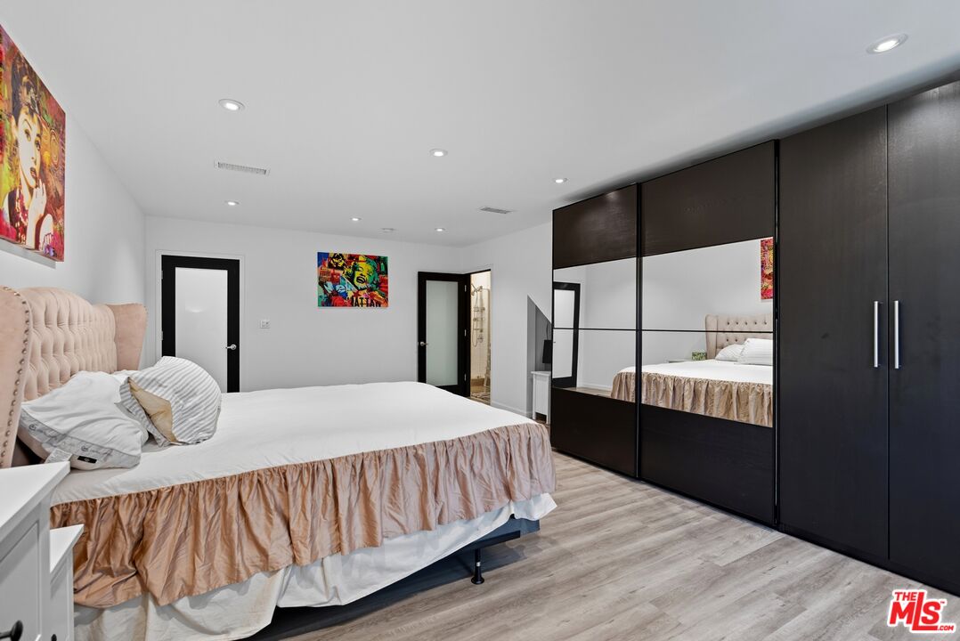 10915 Ayres Avenue Los Angeles, CA 90064 - Photo 22 of 51 a bedroom with a bed and a window