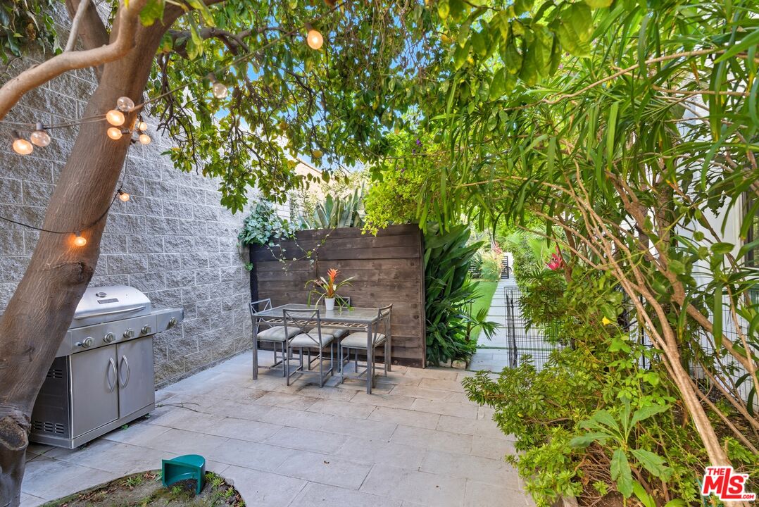 10915 Ayres Avenue Los Angeles, CA 90064 - Photo 34 of 51 a view of a patio with table and chairs and potted plants