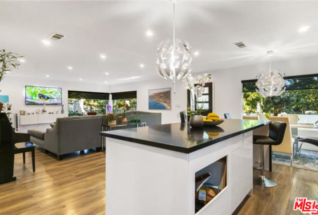 10915 Ayres Avenue Los Angeles, CA 90064 - Photo 4 of 51 a kitchen with kitchen island stainless steel appliances a table and chairs in it