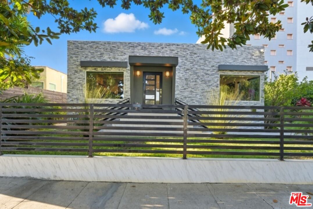 10915 Ayres Avenue Los Angeles, CA 90064 - Photo 43 of 51 a view of a house with a small yard and plants