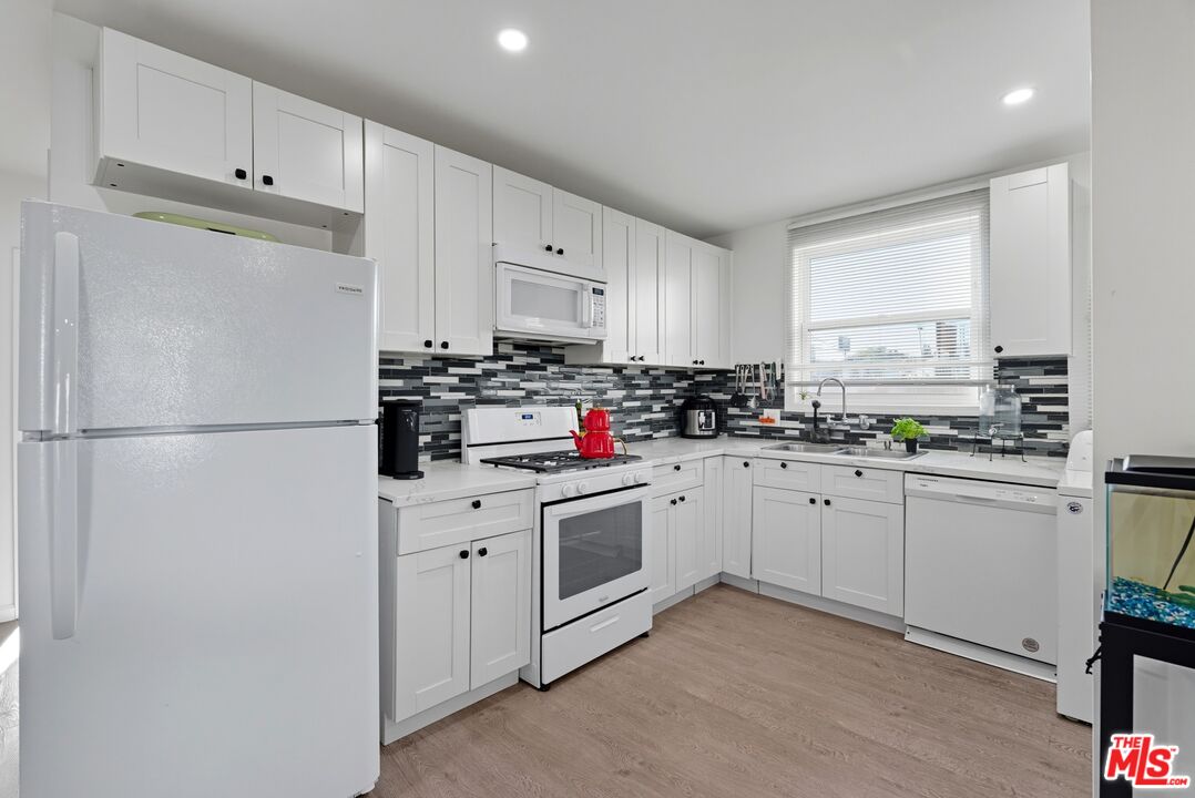 10915 Ayres Avenue Los Angeles, CA 90064 - Photo 45 of 51 a kitchen with cabinets stainless steel appliances and a window