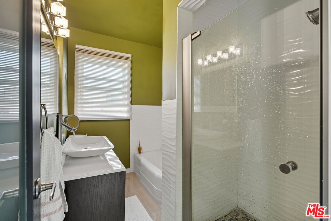 10915 Ayres Avenue Los Angeles, CA 90064 - Photo 48 of 51 a bathroom with a sink a mirror and a shower
