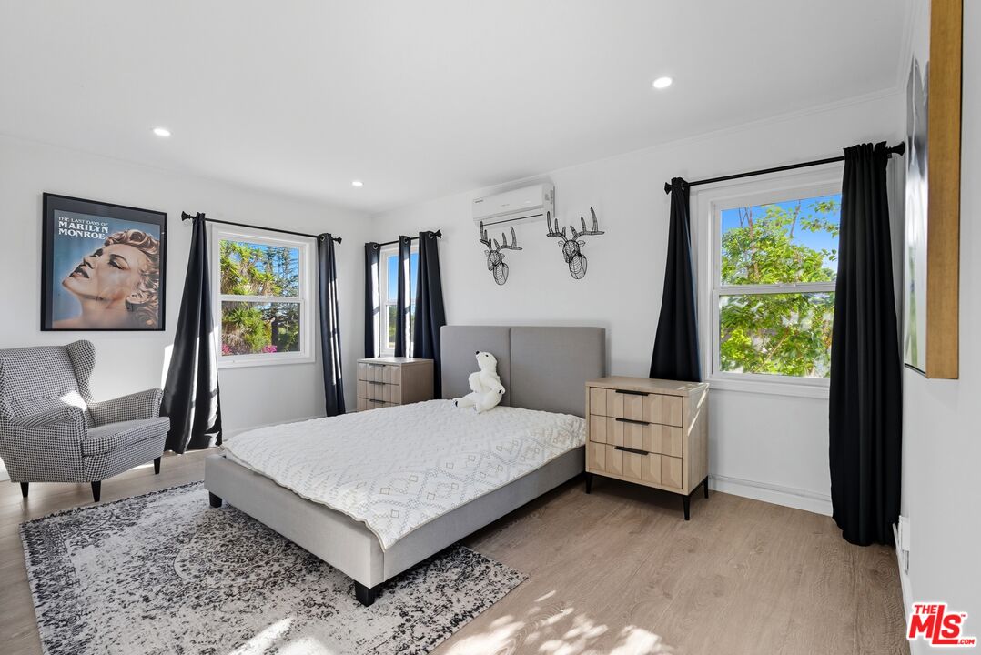 10915 Ayres Avenue Los Angeles, CA 90064 - Photo 49 of 51 a bedroom with a large bed and a window