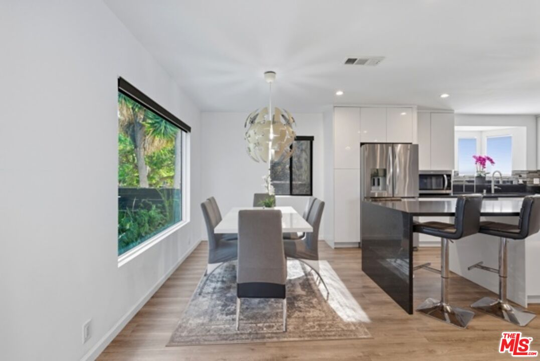 10915 Ayres Avenue Los Angeles, CA 90064 - Photo 10 of 51 a dining room with furniture and a floor to ceiling window