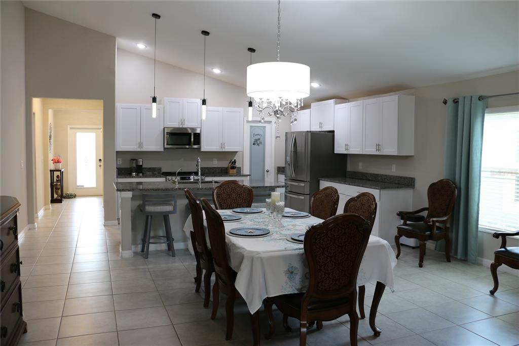 16554 Delia Street Wimauma, FL 33598 - Photo 14 of 44 a kitchen with a dining table cabinets and appliances