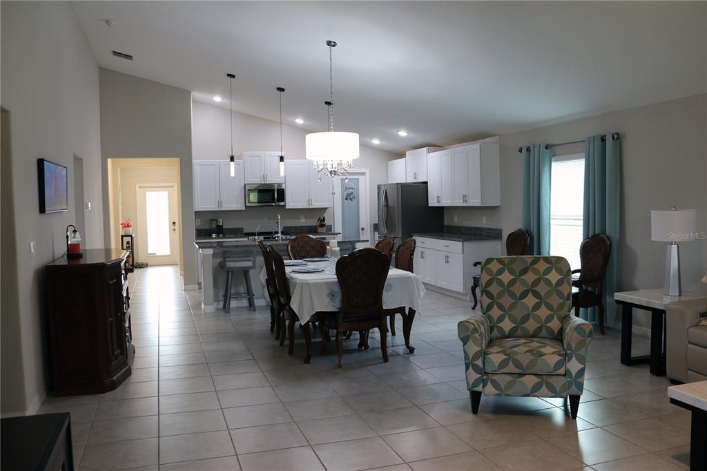 16554 Delia Street Wimauma, FL 33598 - Photo 15 of 44 a living room with furniture and kitchen view