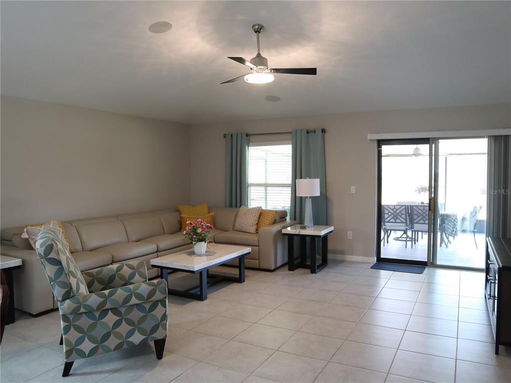 16554 Delia Street Wimauma, FL 33598 - Photo 17 of 44 a living room with furniture and a large window
