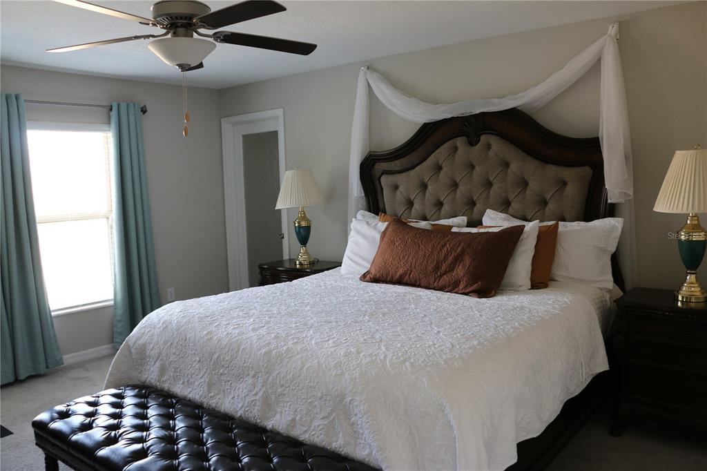 16554 Delia Street Wimauma, FL 33598 - Photo 18 of 44 a bedroom with a bed and a window