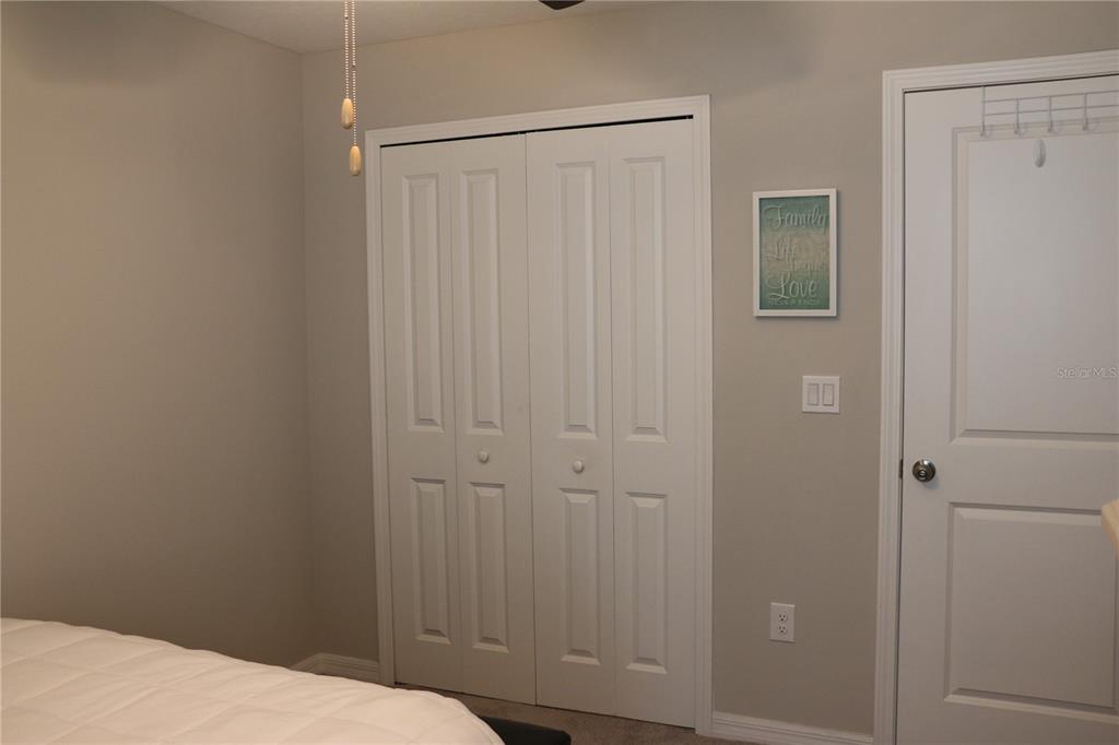 16554 Delia Street Wimauma, FL 33598 - Photo 27 of 44 a bedroom with a bed and closet