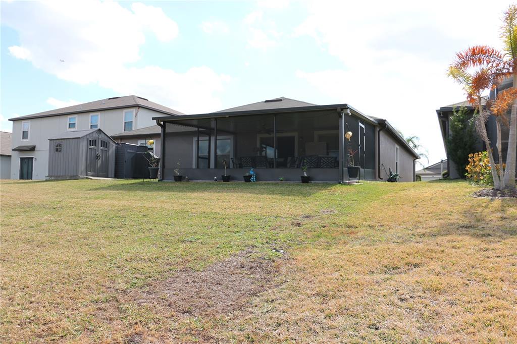 16554 Delia Street Wimauma, FL 33598 - Photo 31 of 44 a view of a house with a yard