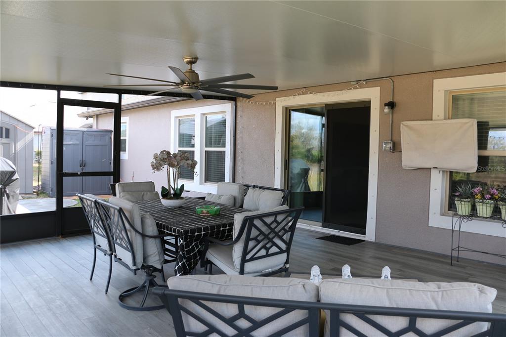 16554 Delia Street Wimauma, FL 33598 - Photo 36 of 44 a view of a dining room with furniture and wooden floor