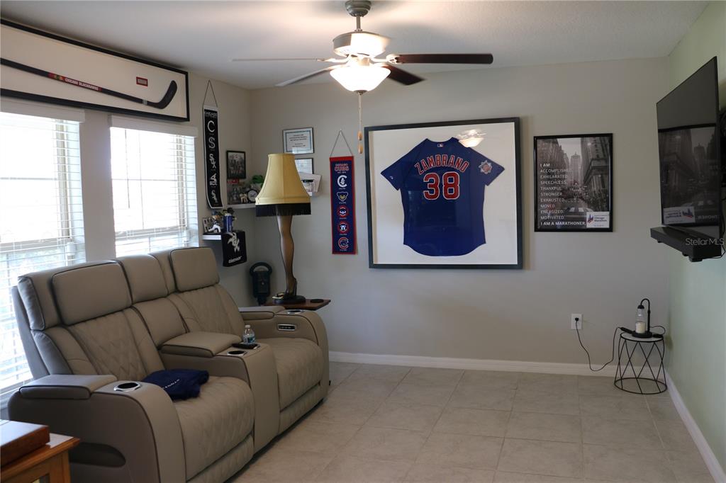 16554 Delia Street Wimauma, FL 33598 - Photo 9 of 44 a living room with furniture a flat screen tv and a window