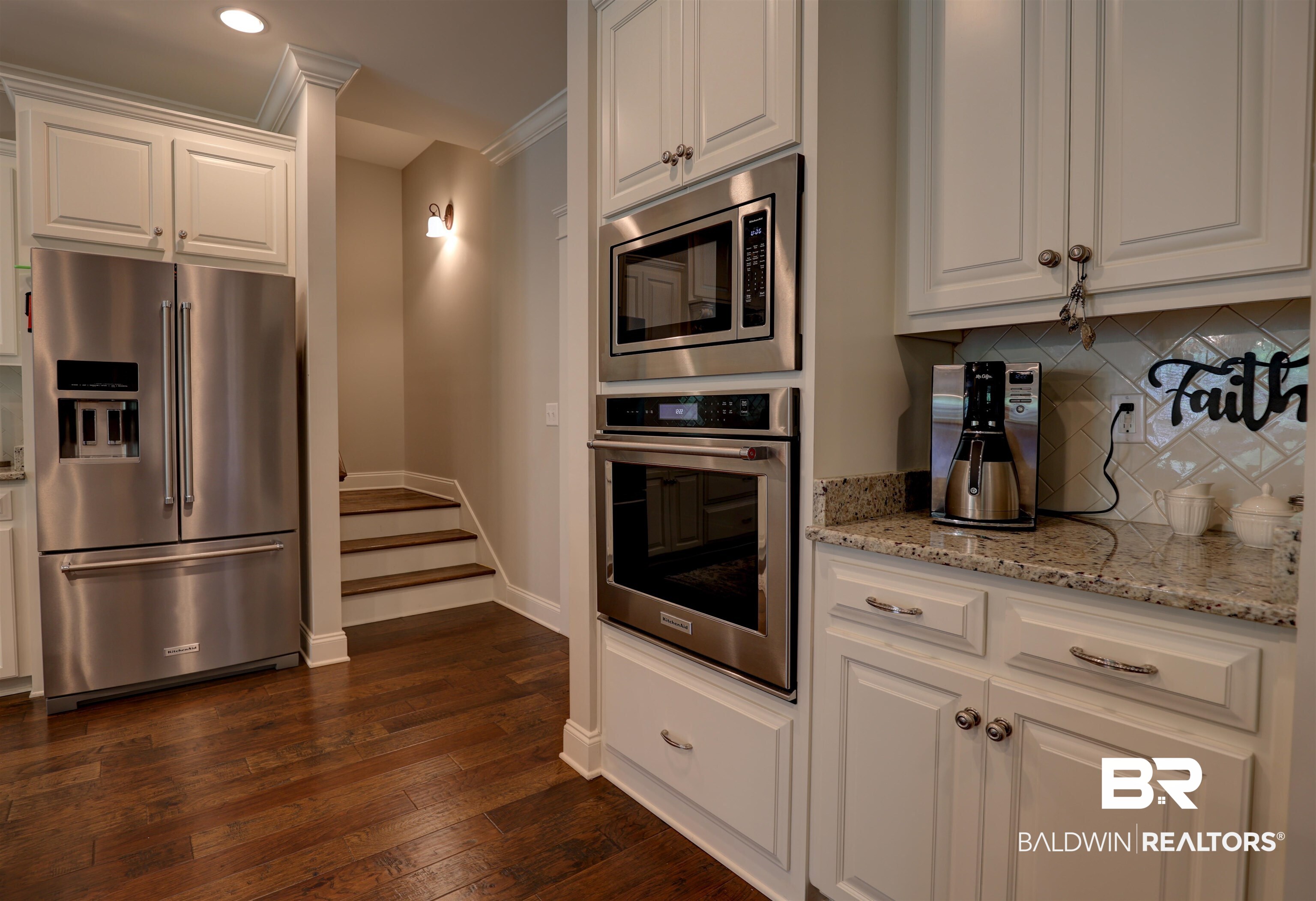 10588 Leesburg Pike Daphne, AL 36526 - Photo 10 of 29 Kitchen featuring white cabinets, backsplash, dark wood-type flooring, stainless steel appliances, and ornamental molding