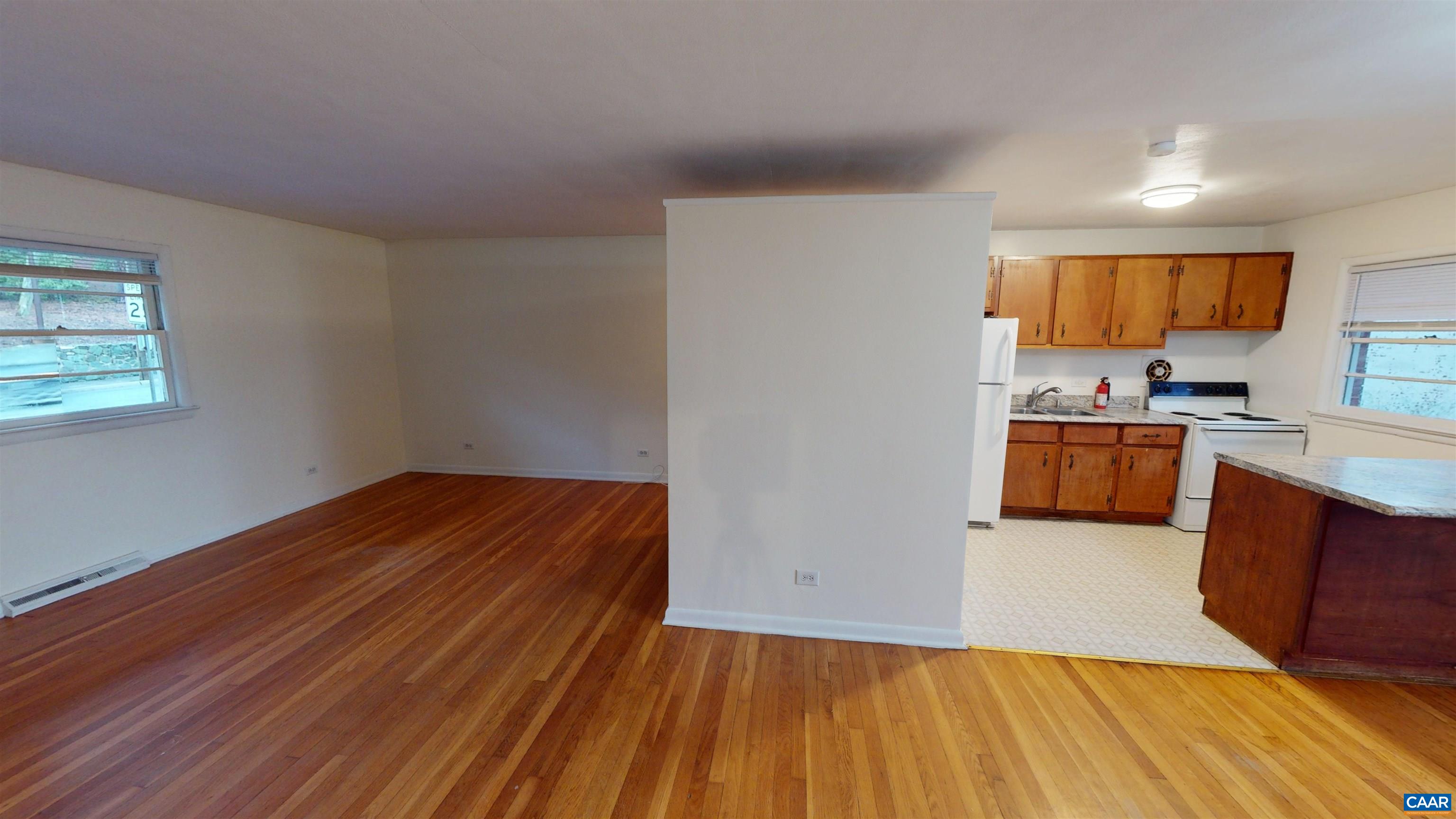 130 Apple Tree Road, Unit A Charlottesville, VA 22903 - Photo 1 of 16 a kitchen with wooden floors and wooden cabinets