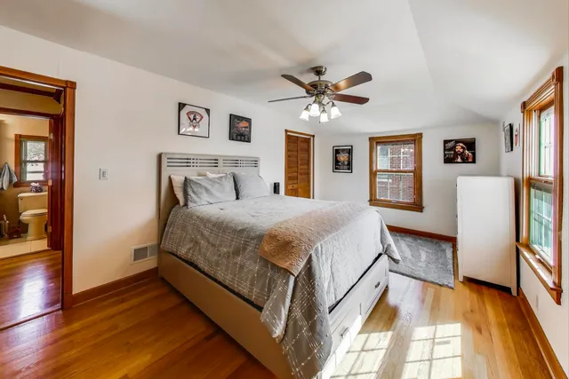 a spacious bedroom with a bed and a chandelier