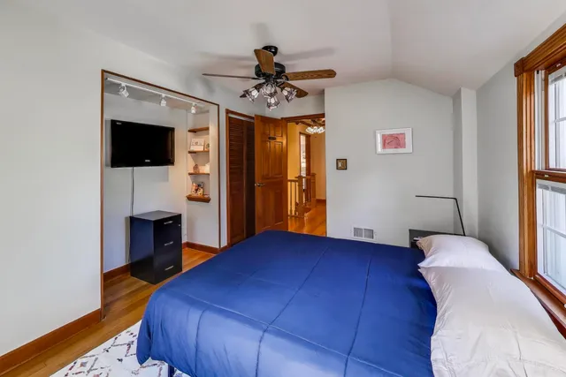 a bedroom with a bed and a flat screen tv