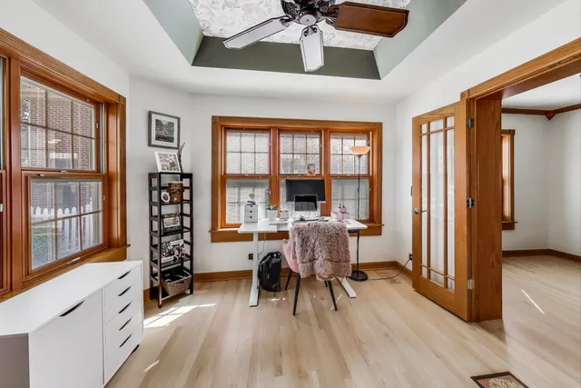 a workspace with wooden floor and furniture