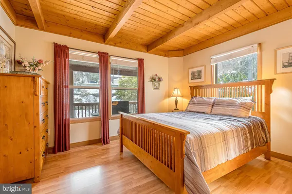 a bedroom with a large bed and a large window