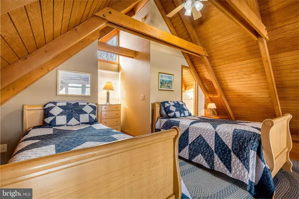 a living room with furniture a couch and windows