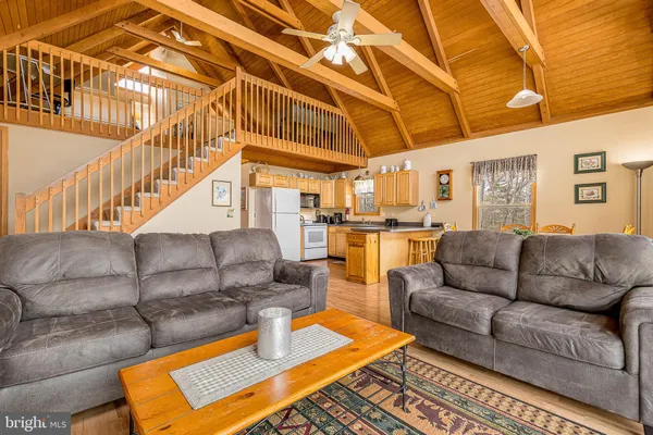 a living room with furniture and a chandelier