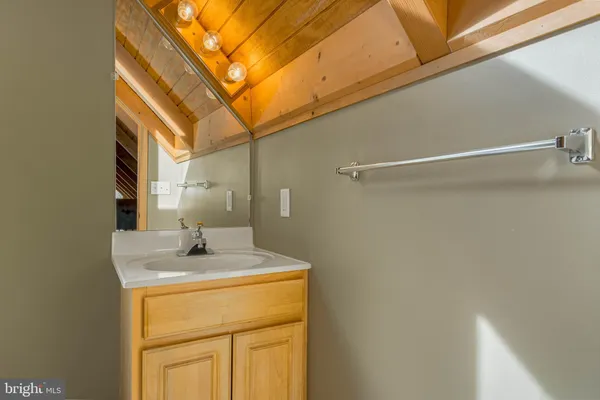 a bathroom with a sink and vanity
