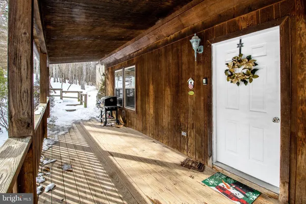 a view of a porch with a table and chairs