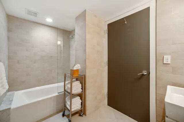 a bathroom with a bathtub and a shower