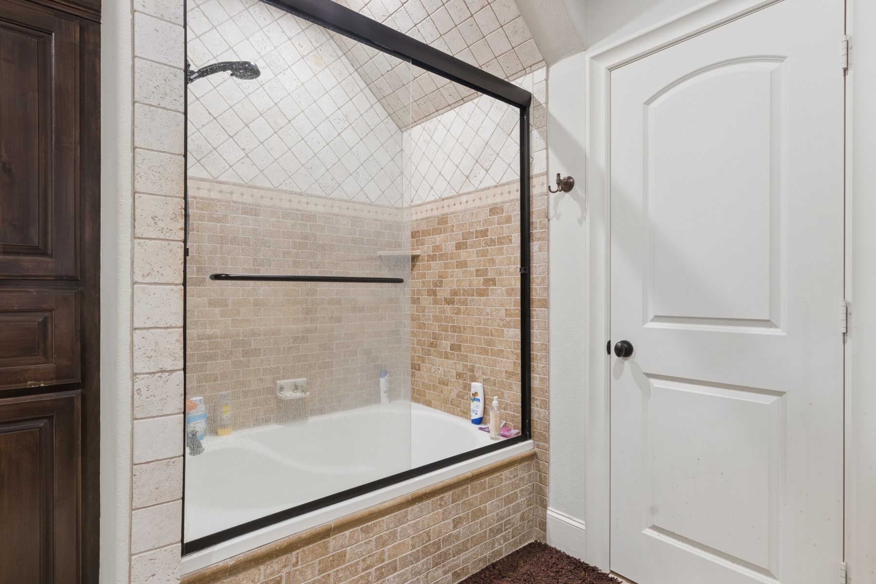 3818 Waterbend Cove Spring, TX 77386 - Photo 33 of 44 a bathroom with a bathtub and a shower