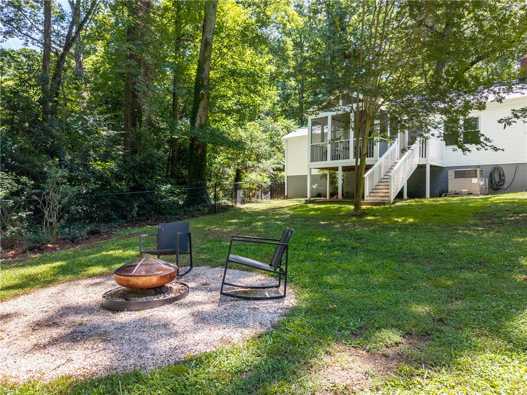 203 Augusta Road Clemson, SC 29631 - Photo 26 of 31 A private backyard retreat with a charming fire pit area, perfect for outdoor gatherings.