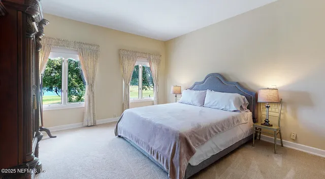 a bed room with a bed and a chair