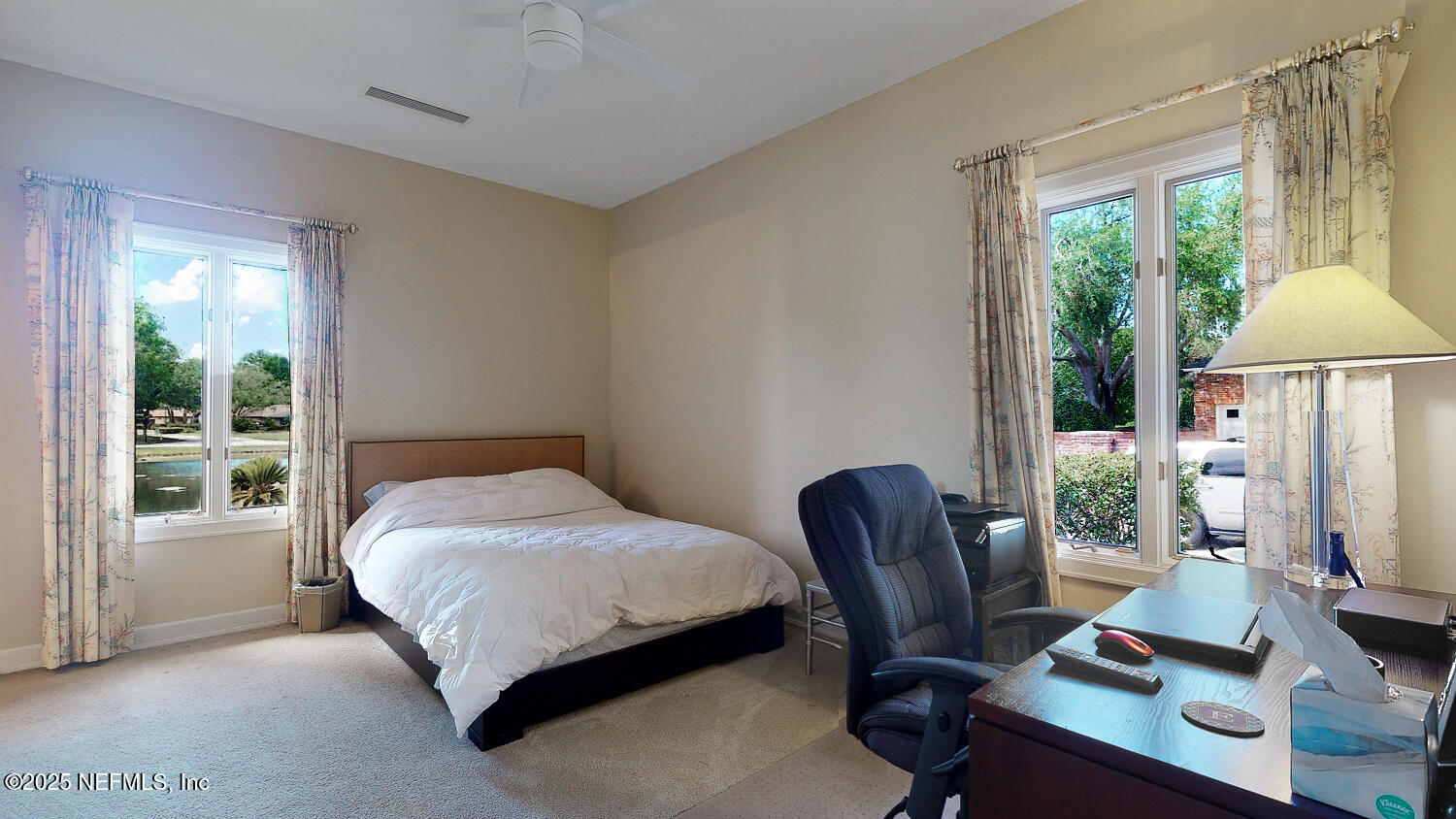 7987 Hollyridge Road Jacksonville, FL 32256 - Photo 13 of 55 a bedroom with a bed and a desk