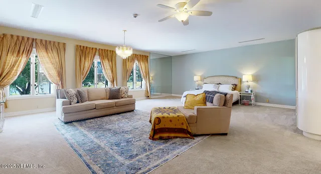 a bedroom with furniture and a flat screen tv