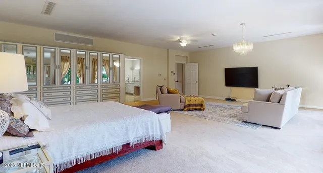 a living room with furniture a flat screen tv and a large window