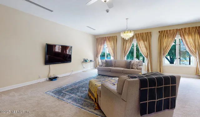 a view of a dining room with furniture and chandelier