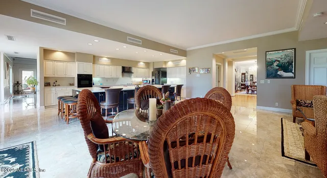 a view of a house with a yard and potted plants