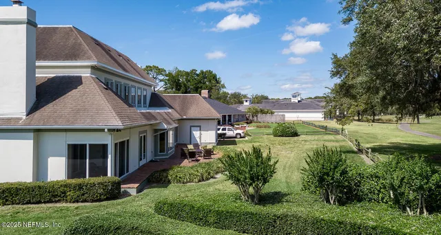 an aerial view of a house with a yard
