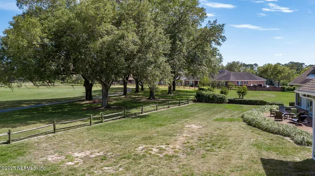 a aerial view of a house with garden space and street view