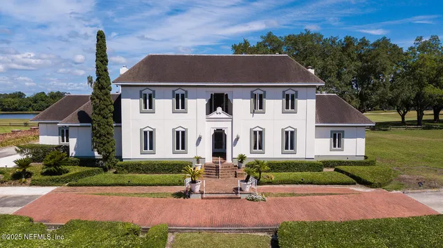an aerial view of a house with garden space and street view