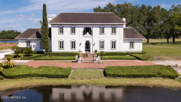 an aerial view of a house with a lake view