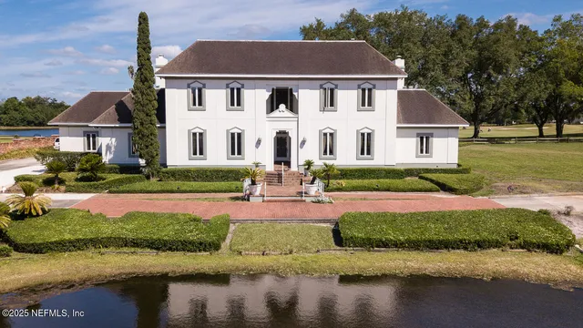 an aerial view of a house with a lake view