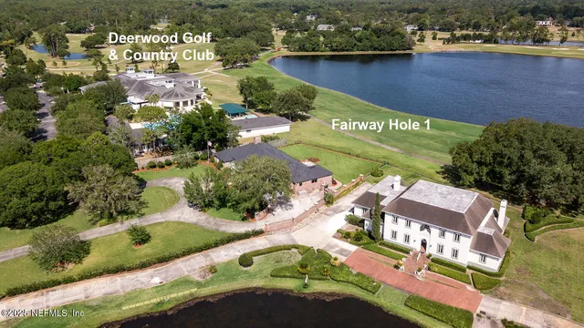 a aerial view of a house with swimming pool and a yard
